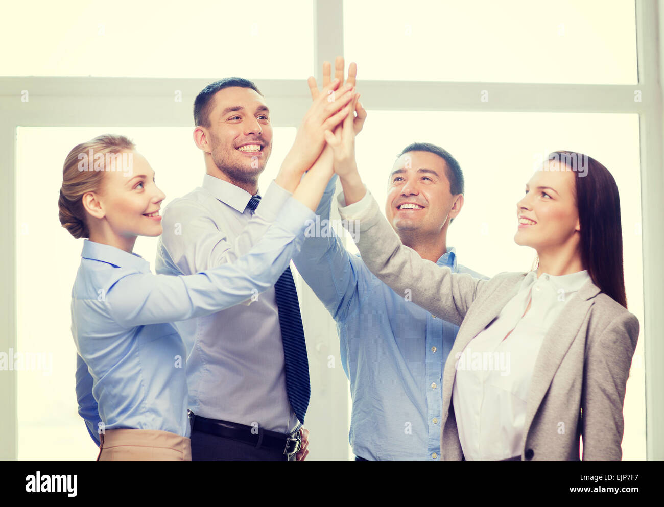 happy business team giving high five in office Stock Photo - Alamy