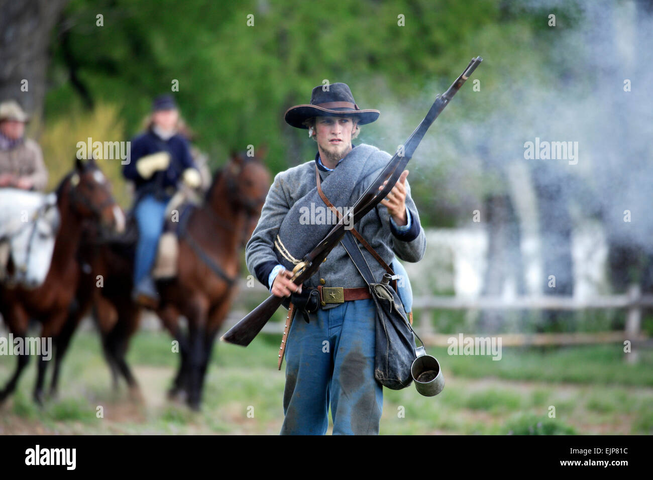 Confederate Army soldier after firing gun, Civil War reenactment, Rancho de las Golondrinas Living History Museum, New Mexico US Stock Photo