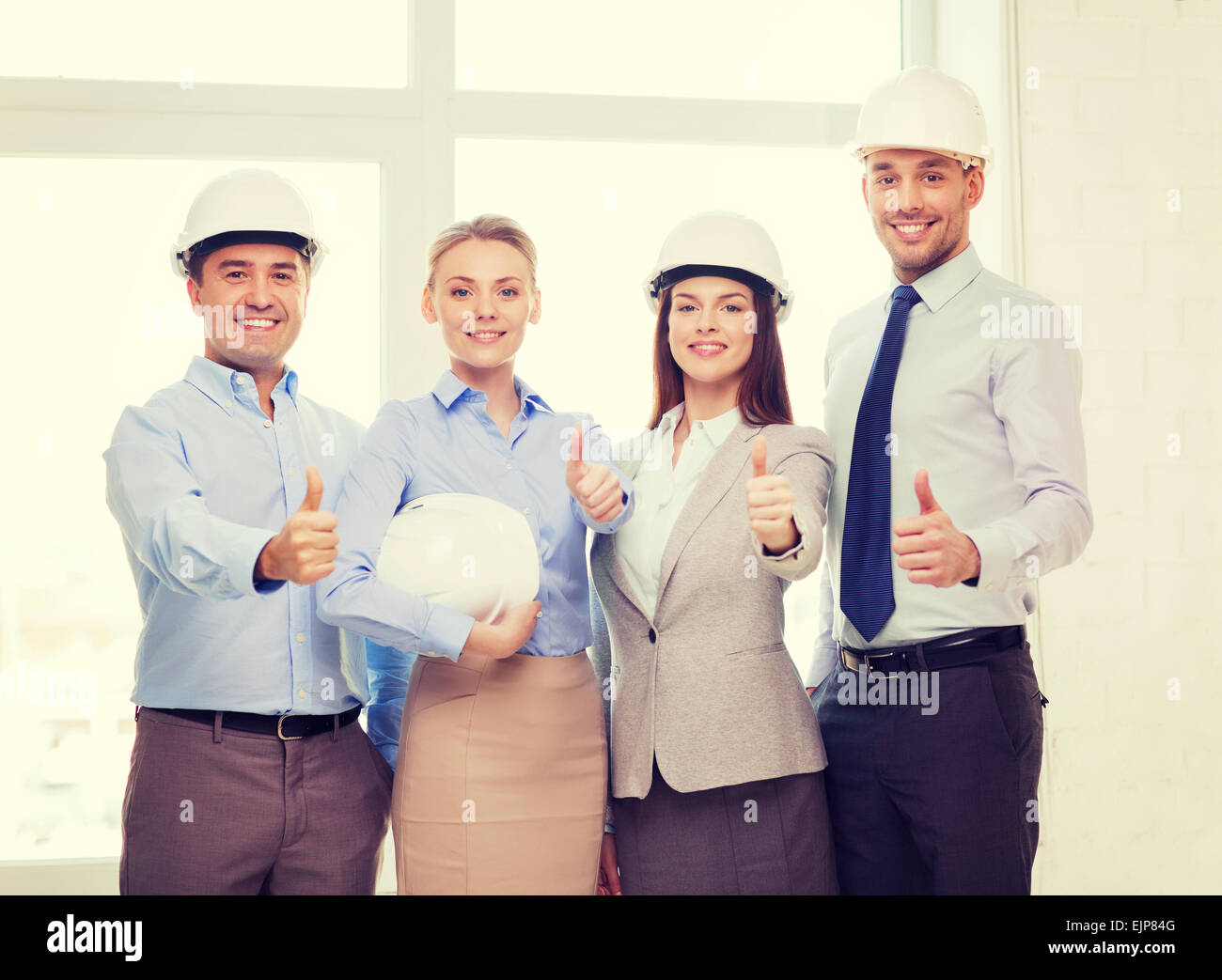 happy business team in office showing thumbs up Stock Photo - Alamy