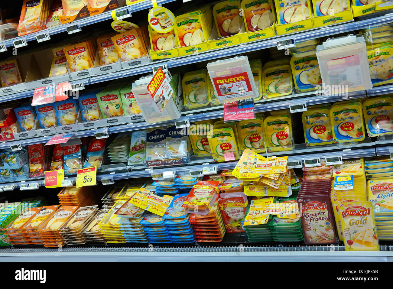 WALLONIA, BELGIUM - OCTOBER 2014: Refrigerated shelves with a variety of sliced cheese packages at a Carrefour Hypermarket Stock Photo