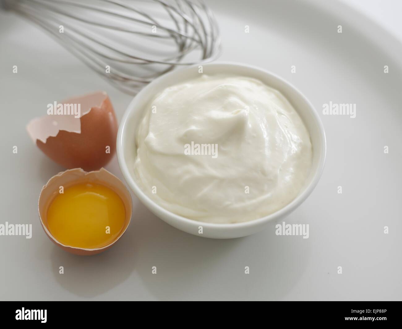 ramekin of Mayo and egg shell Stock Photo - Alamy