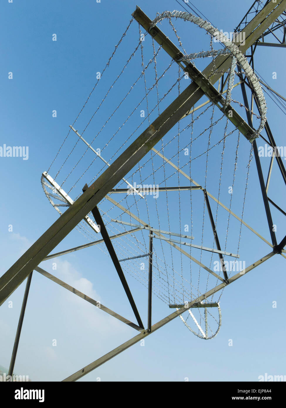 Barbed wire barrier around base of electricity pylon Stock Photo Alamy