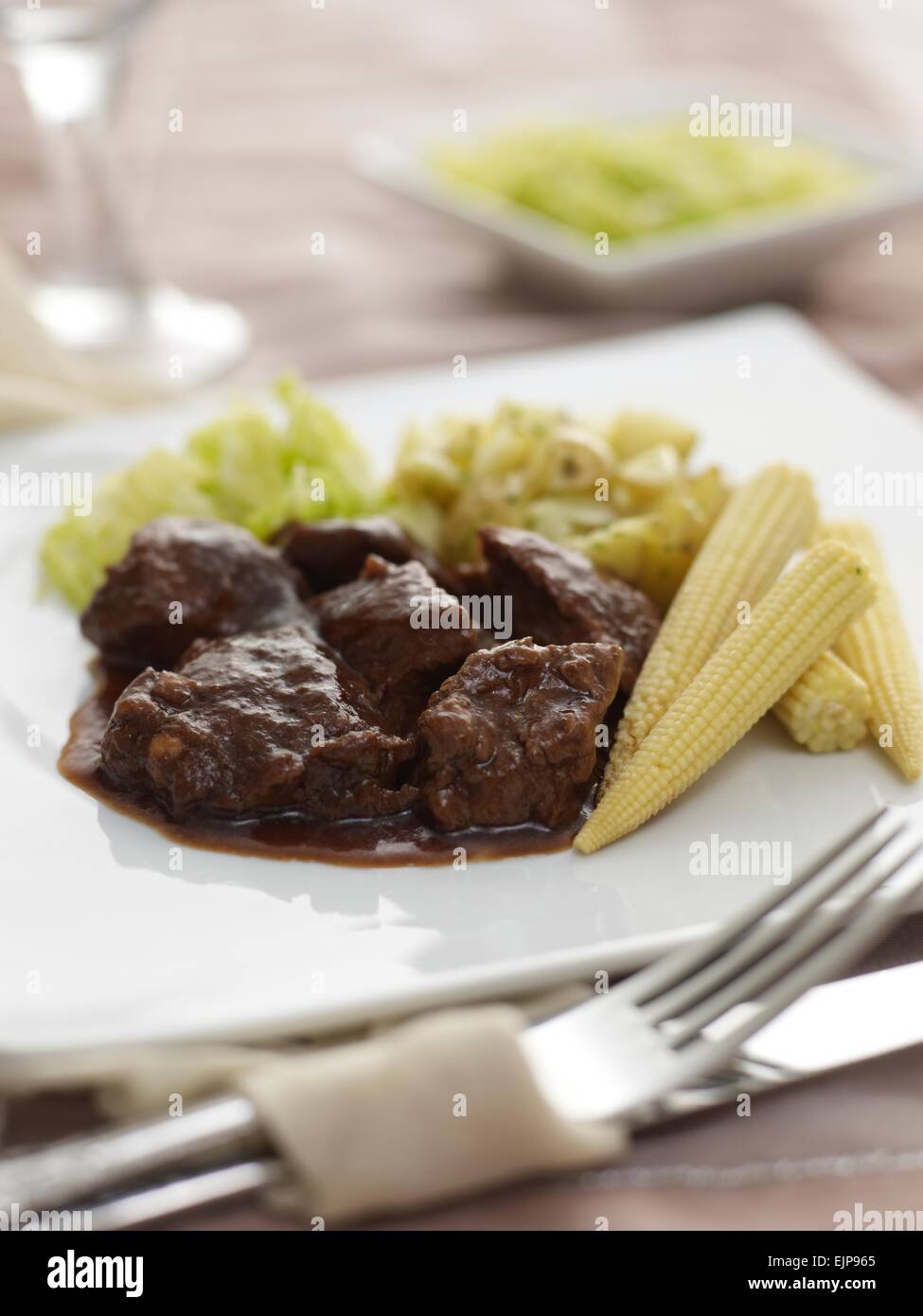 diced cubes of Beef in gravy stew baby corn cabbage new potatoes Stock Photo