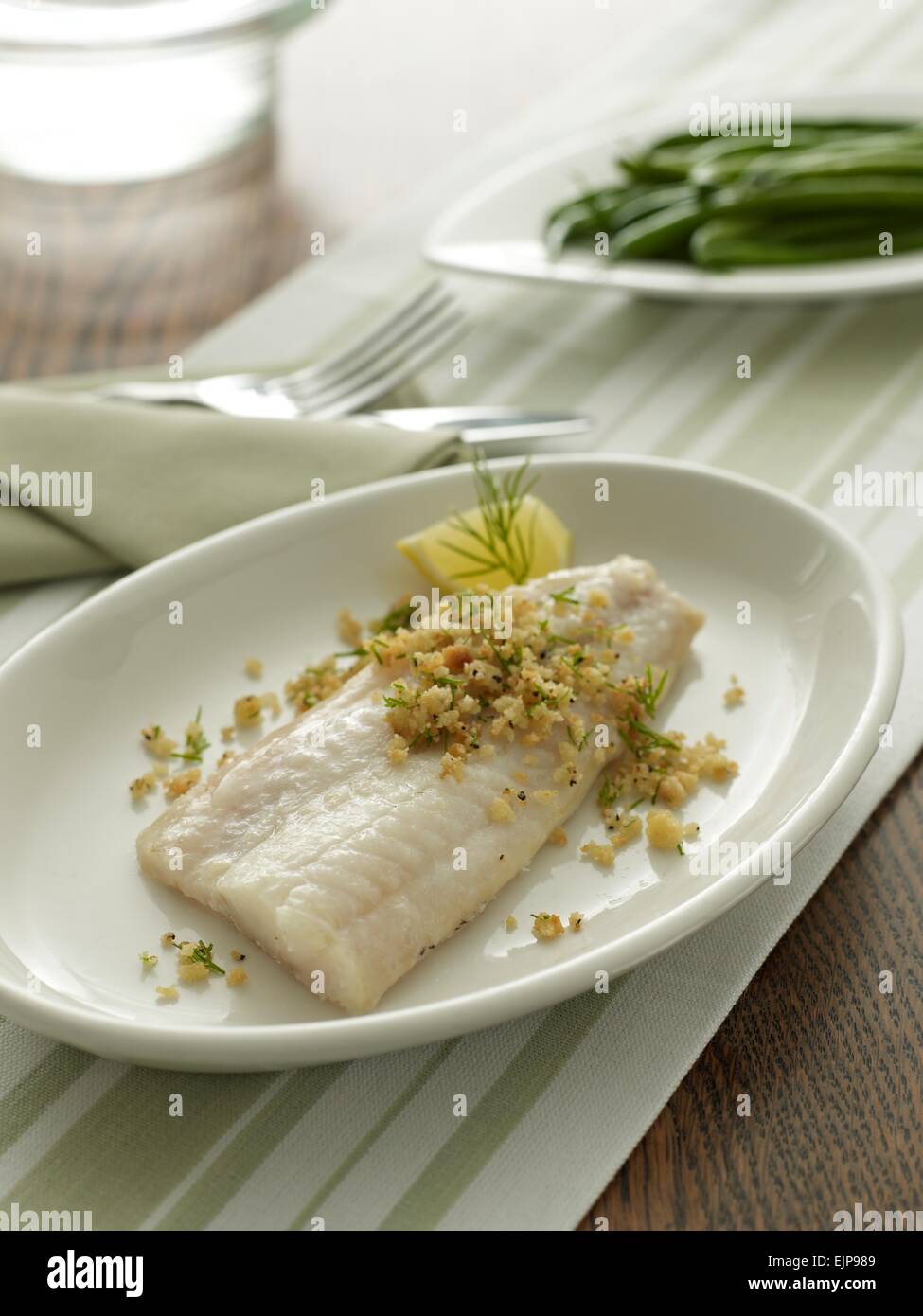 Plated meal of plain fillet of haddock or cod fish with lemon dill and
