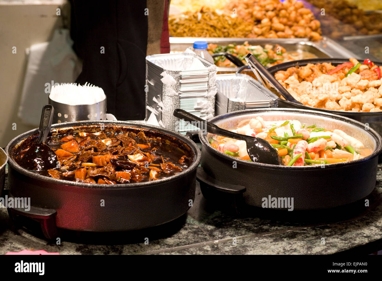 Chinese food cooking in Pans on a stall in Camden London Stock Photo