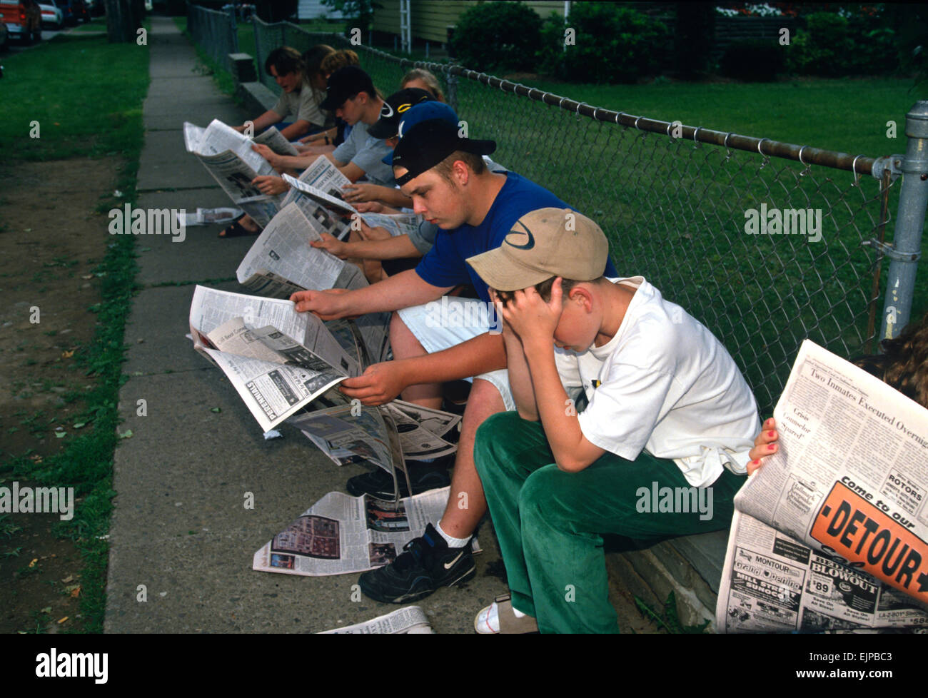 Students mourn their friends killed aboard TWA Airlines Flight 800 as they read news reports of the tragedy July 18, 1996 in Montoursville, PA. TWA Flight 800 exploded off East Moriches, NY with the loss of 230 lives including 21 students from the town. Stock Photo