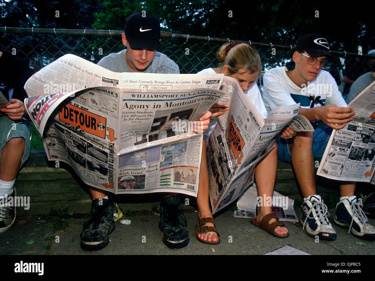 Students mourn their friends killed aboard TWA Airlines Flight 800 as they read news reports of the tragedy July 18, 1996 in Montoursville, PA. TWA Flight 800 exploded off East Moriches, NY with the loss of 230 lives including 21 students from the town. Stock Photo
