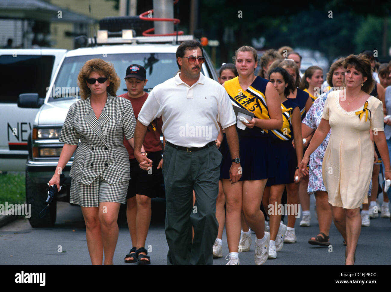 Families of the 21 students and chaperones killed aboard TWA Airlines Flight 800 walk together to a memorial service July 18, 1996 in Montoursville, PA. TWA Flight 800 exploded off East Moriches, NY with the loss of 230 lives. Stock Photo