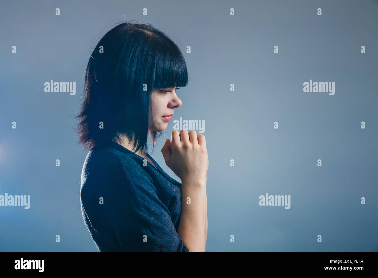 Girl with folded hands hi-res stock photography and images - Alamy