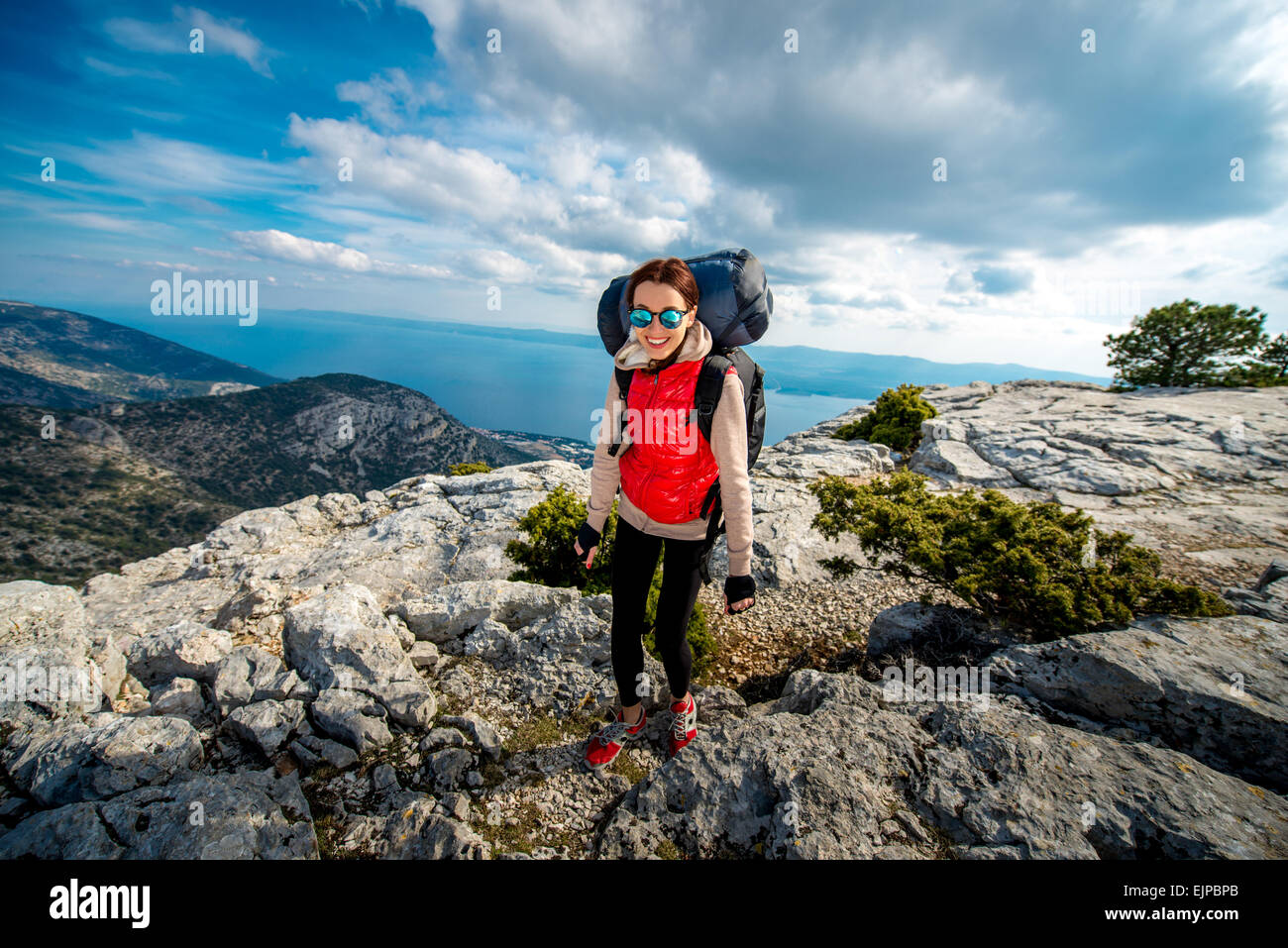Young mountain climber on the top of island Stock Photo