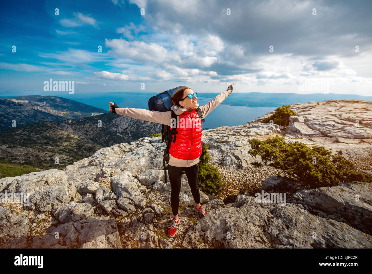 Young mountain climber on the top of island Stock Photo