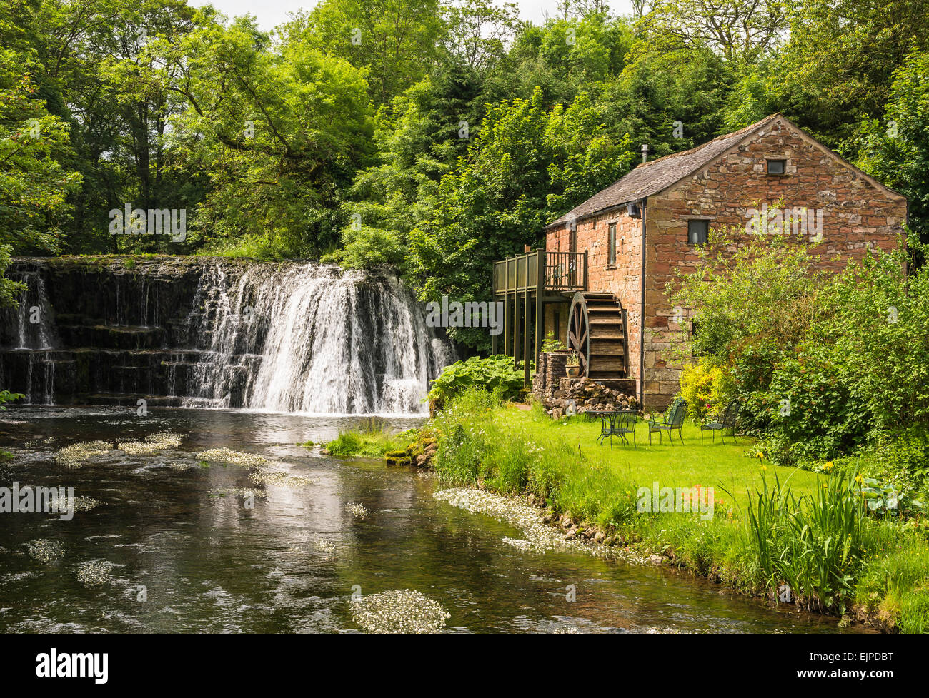 A quintessentially idyllic English rural scene with the Rutter Force waterfall and old watermill Stock Photo