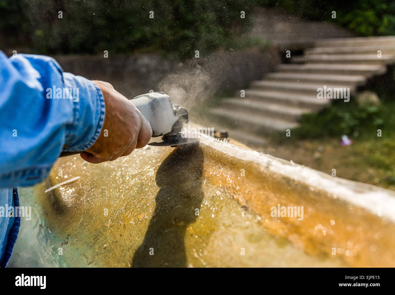 Hand of a worker polishing boat made of resin Stock Photo Alamy