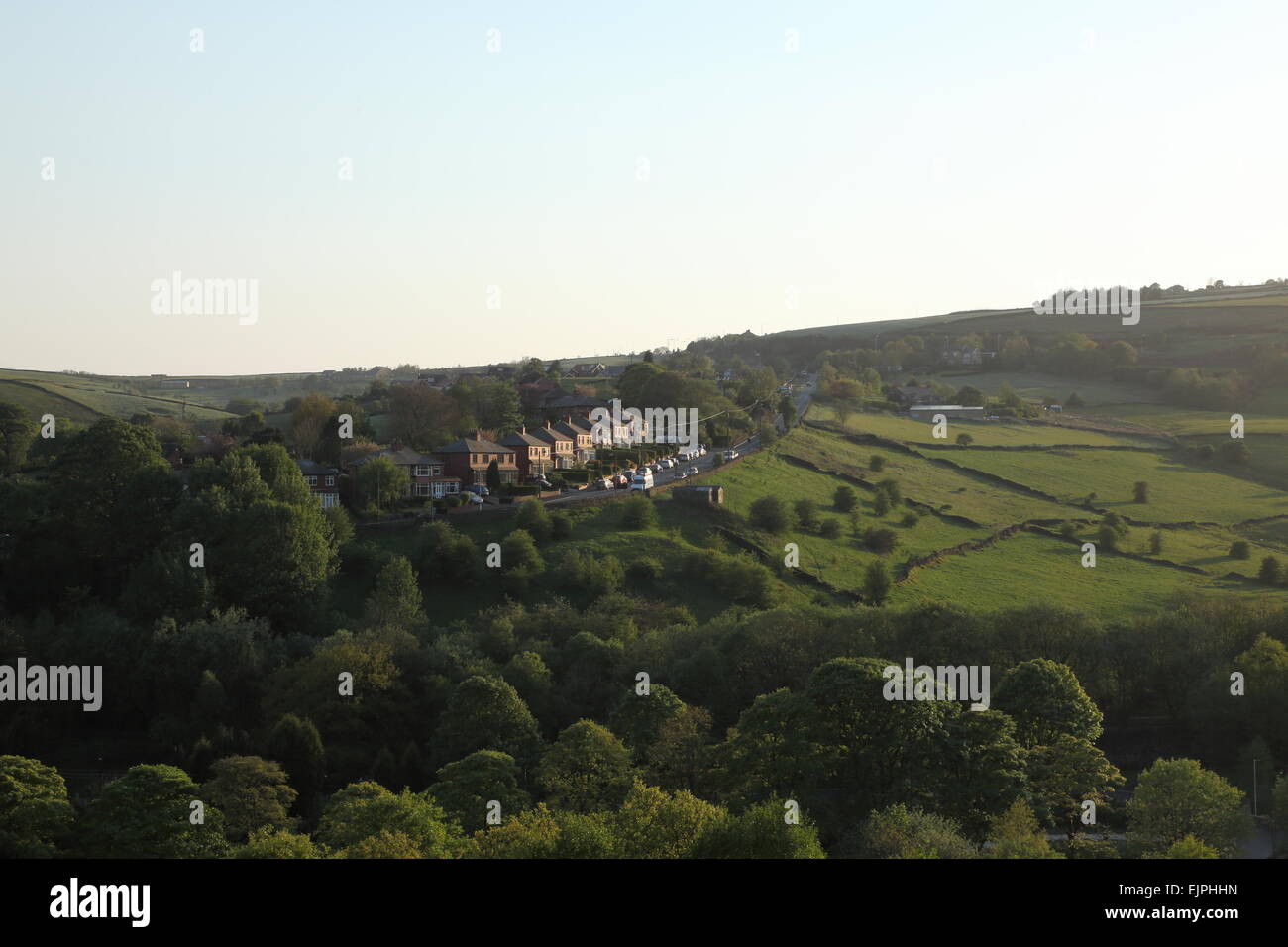 Sunlight catching houses on Wall Hill Road, Dobcross, Saddleworth, Oldham, England, UK Stock Photo