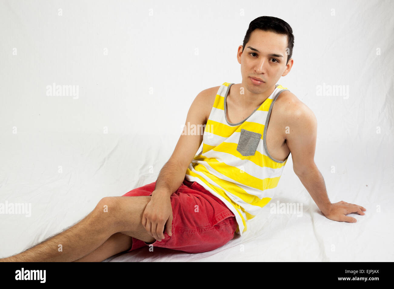 Young man sitting with a serious expression Stock Photo