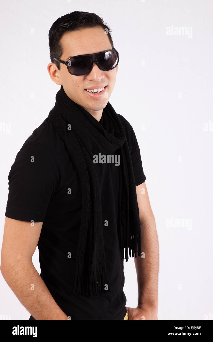 Young man in black shirt and sunglasses, with a smile for the camera ...