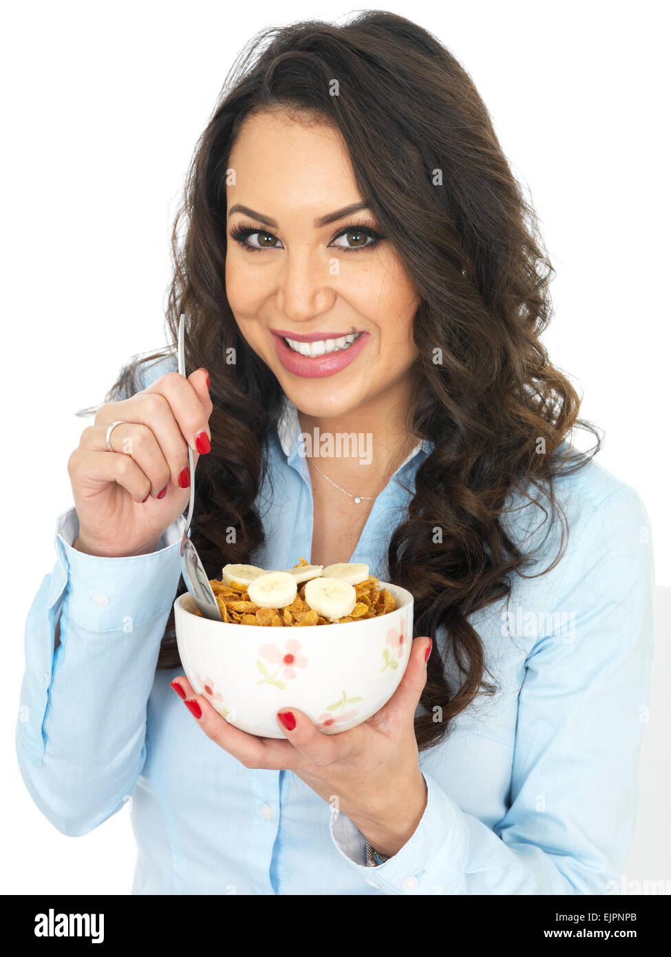 Attractive Young Woman Eating Breakfast Cereals with Banana Stock Photo