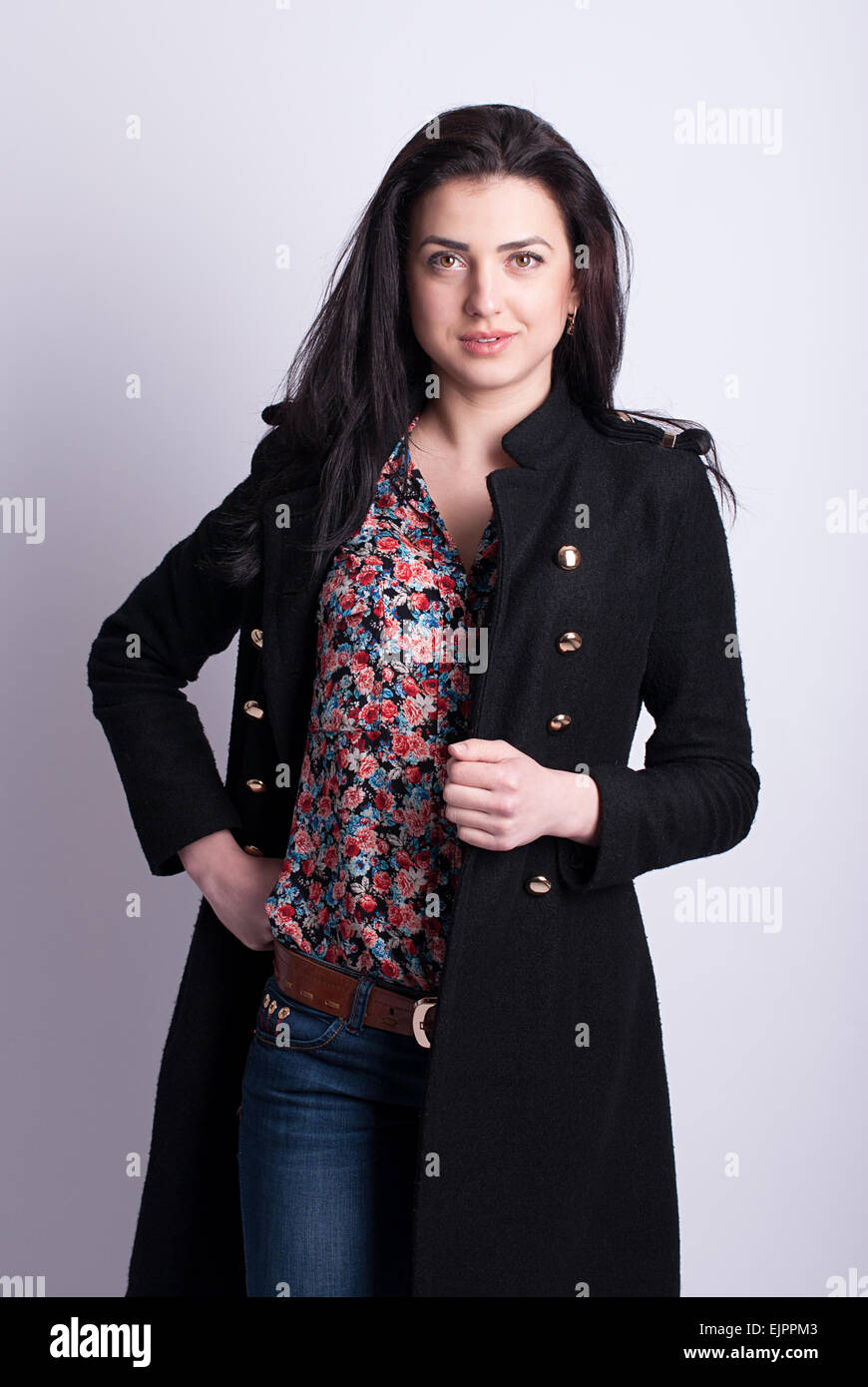 Beautiful girl posing in a black coat Stock Photo - Alamy