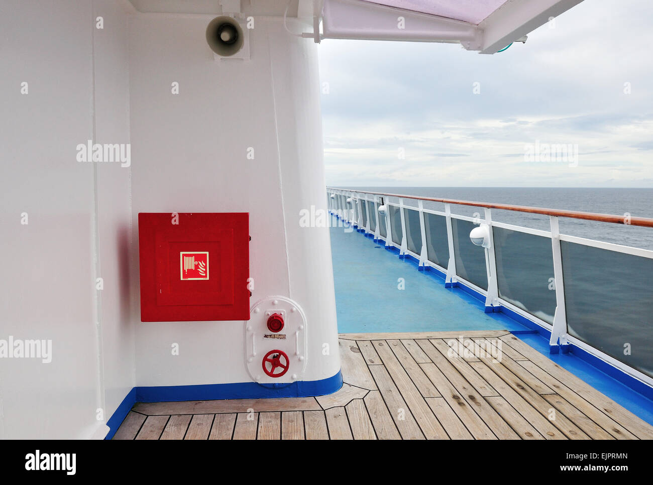 White painted wall of a luxury cruise ship exterior image, with fire hose reel on a wall. Stock Photo