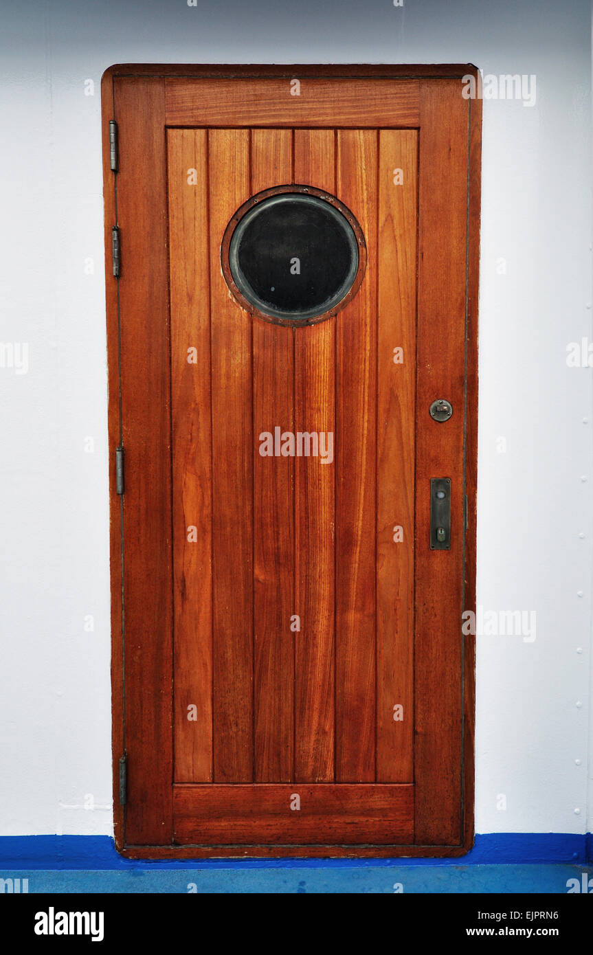 Wooden Porthole door in a ship/cruise. Stock Photo