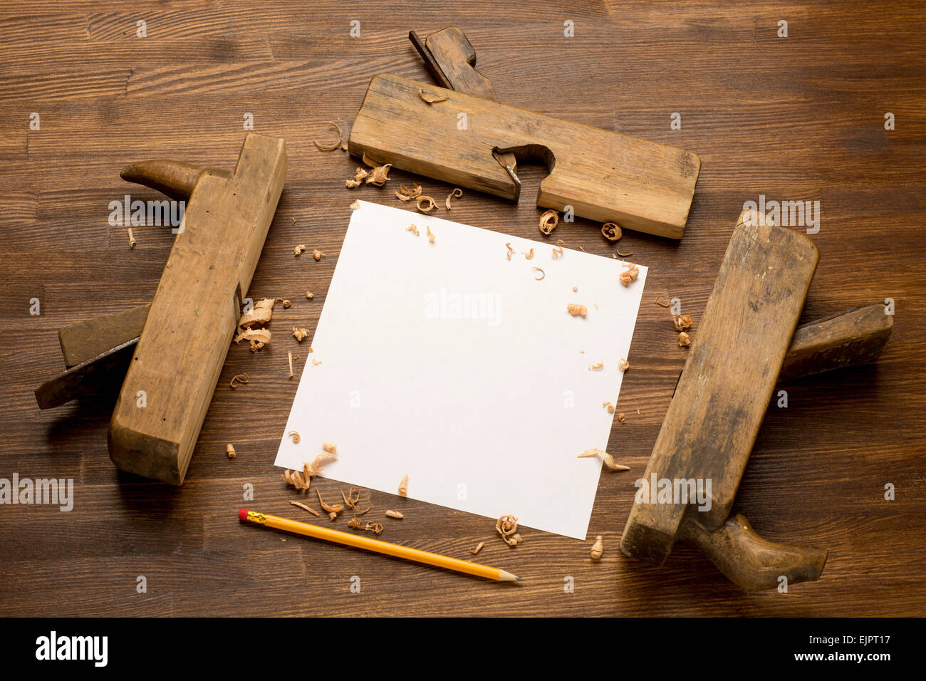 Old wooden jointers on the wood table with grunge texture and paper