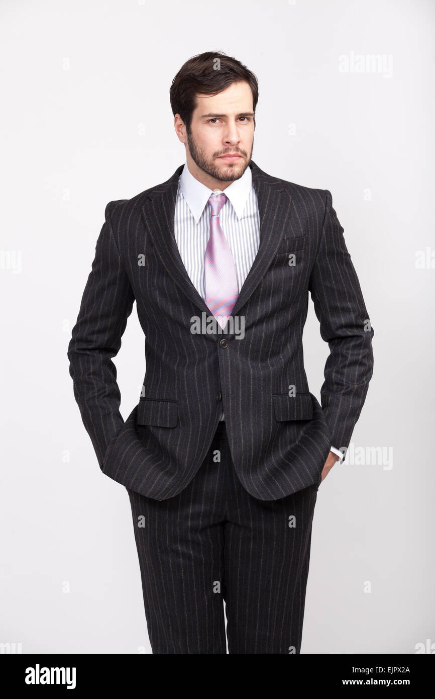 handsome elegant masculine man with beard, dressed in striped suit posing with attitude, isolated Stock Photo