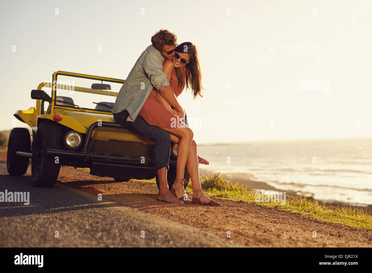 Romantic young couple sharing a special moment while outdoors. Young couple in love on a road trip. Couple embracing each other Stock Photo