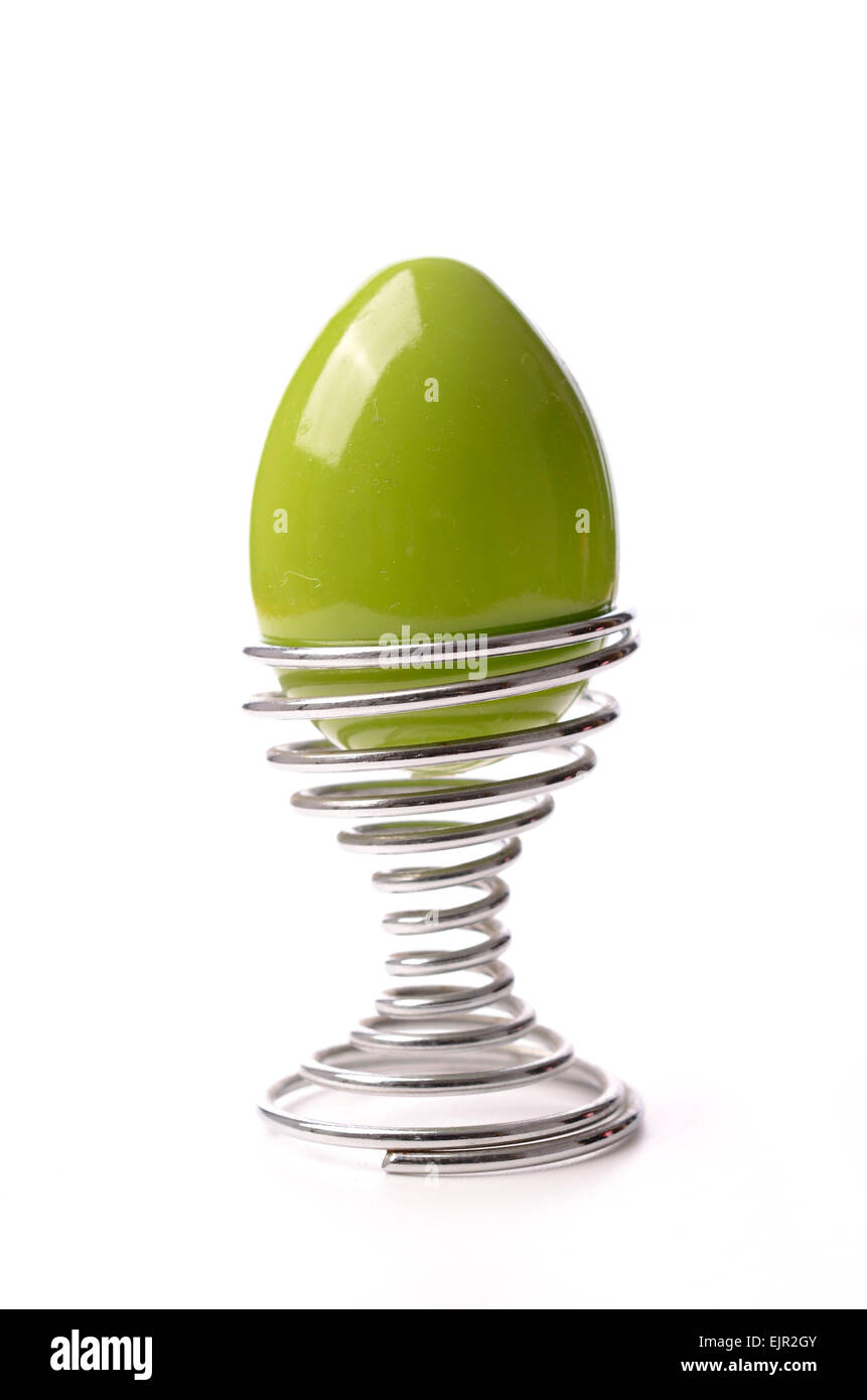 Green Easter egg in an eggcup on a white background Stock Photo