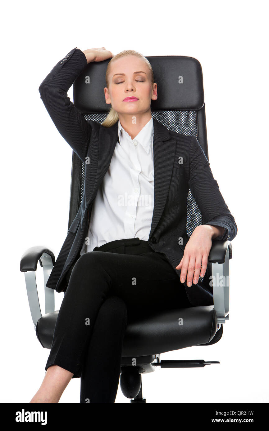 blonde smiling businesswoman relaxing on a chair with eyes closed Stock Photo