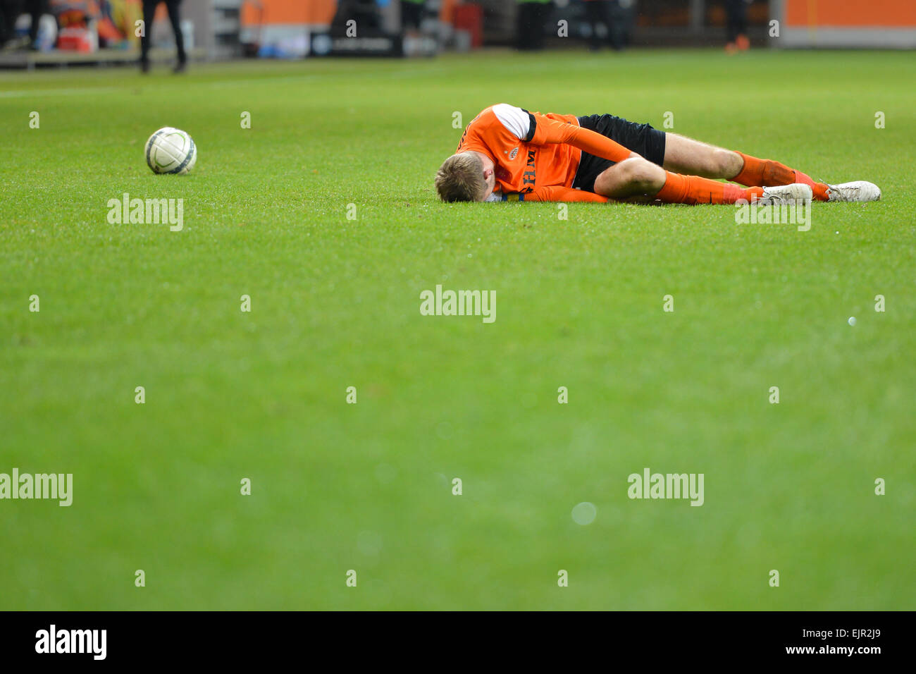 LUBIN, POLAND - DECEMBER 05: Injured Bartosz Rymaniak lying on the grass during match Polish Premier League between KGHM Zaglebi Stock Photo