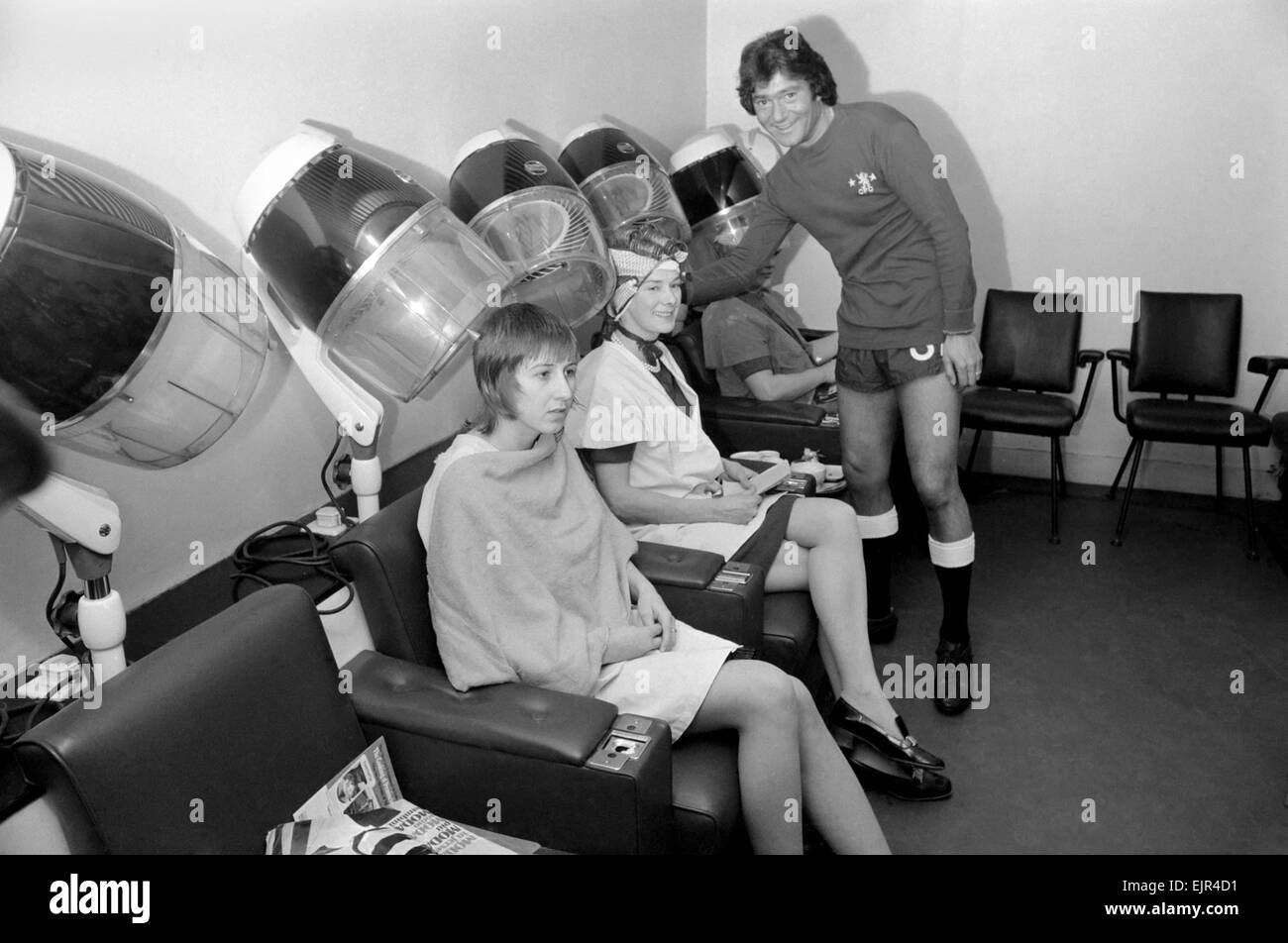 Football fan Vidal Sassoon made a solemn promise that if Chelsea reached the final of the Football League Cup the players and their wives would all get a free hair-do for the occasion. Chelsea are in the Final and Vidal kept this promise. Vidal Sassoon dressed in Chelsea's Football strip seen in the women's hairdressing salon attending to some clients . March 1972 72-2010-011 Stock Photo