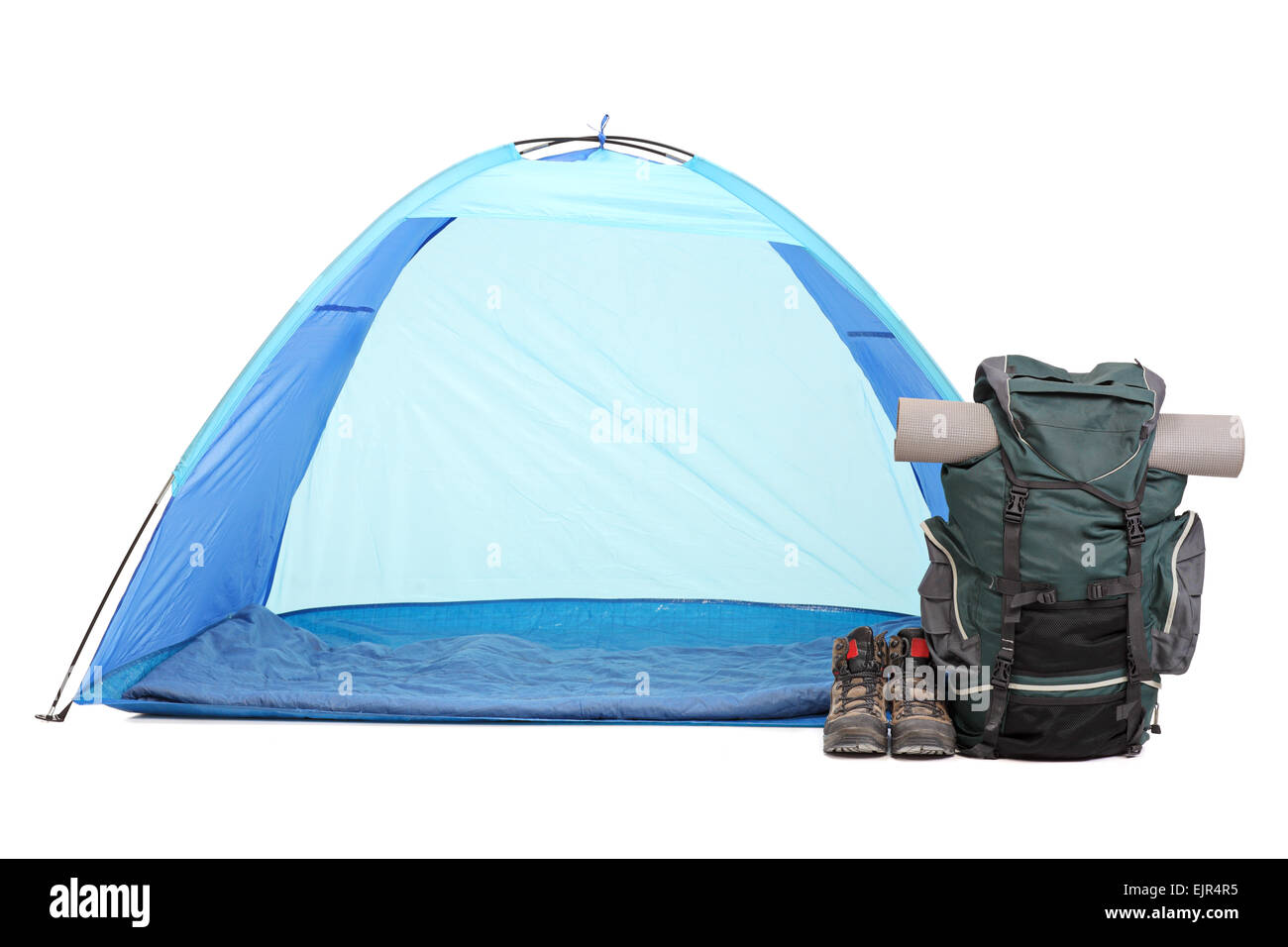 Frontal shot of blue tent, a rucksack with hiking equipment and a pair of boots isolated on white background Stock Photo