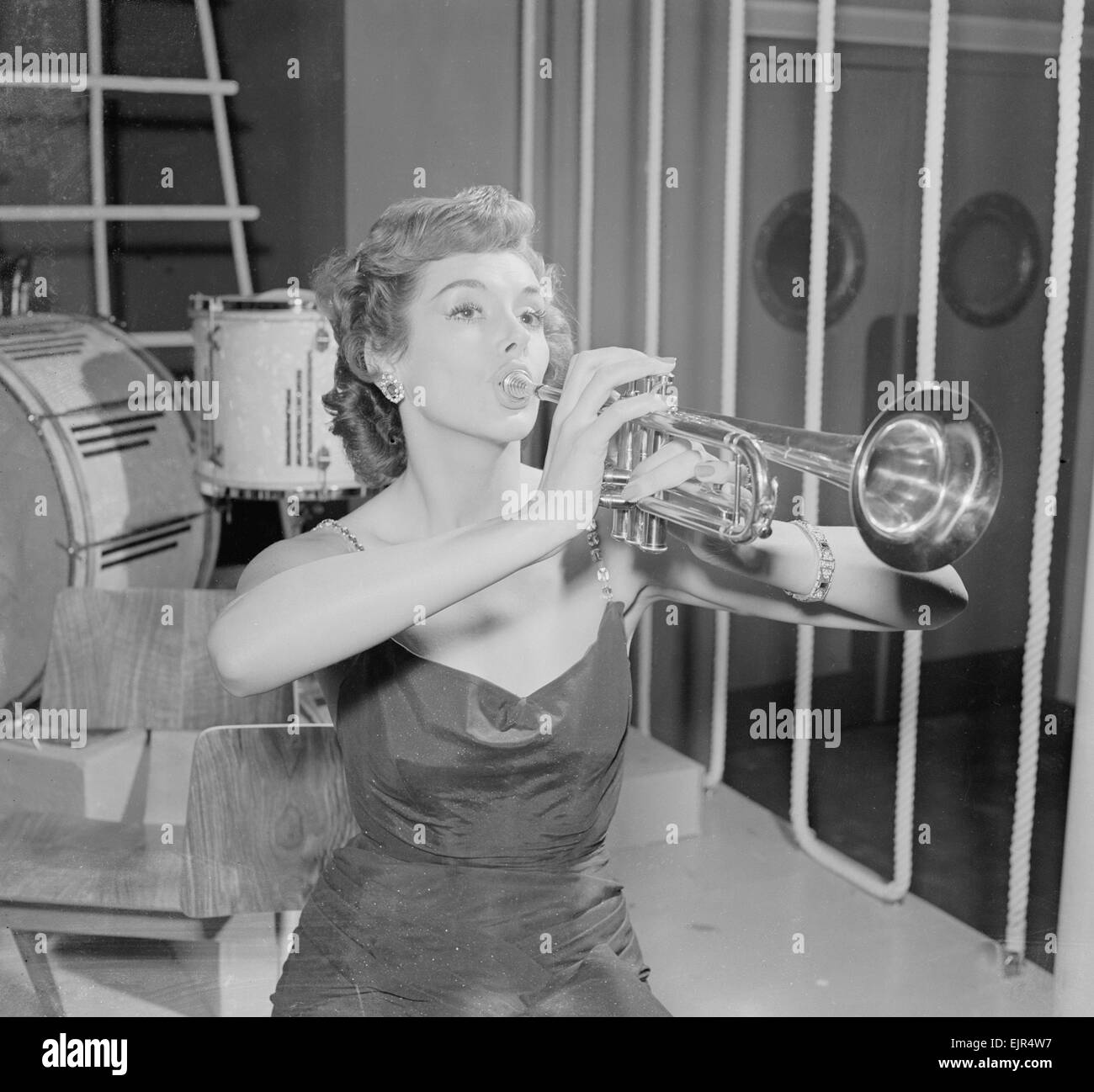 British actress Kay Kendall seen here playing the trumpet. 16th November 1952 Stock Photo