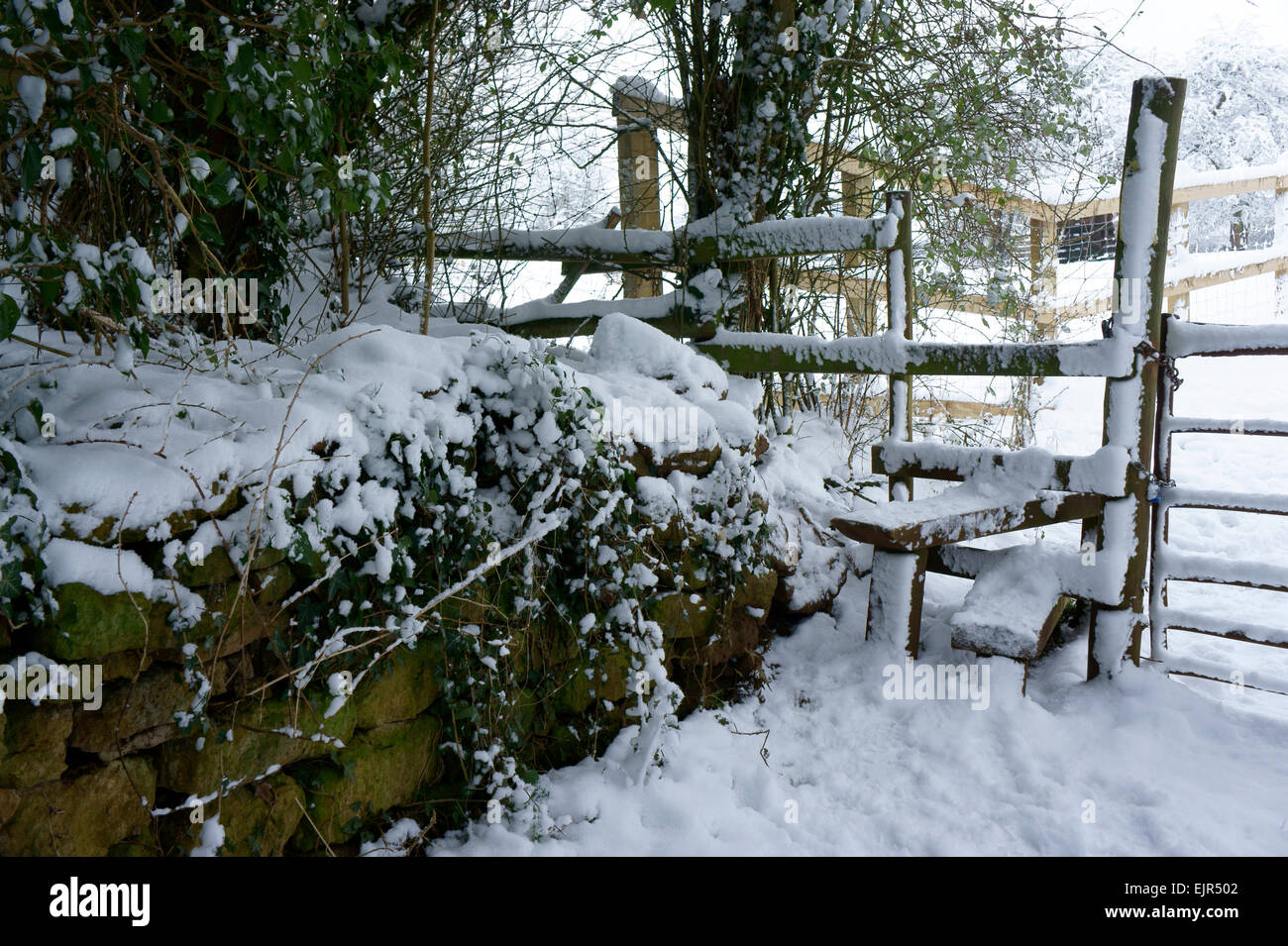 Snow covered stile on footpath route in Oxfordshire, England. Stock Photo