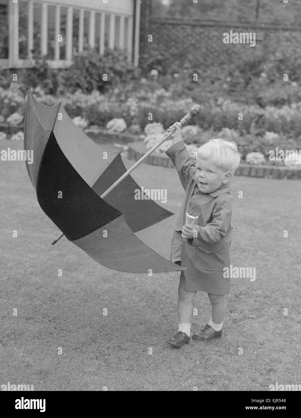 Two year old Angus Cameron seen here with umbrella and his ice cream cone. 30th July 1953 *** Local Caption *** watscan - - 12/01/2010 Stock Photo