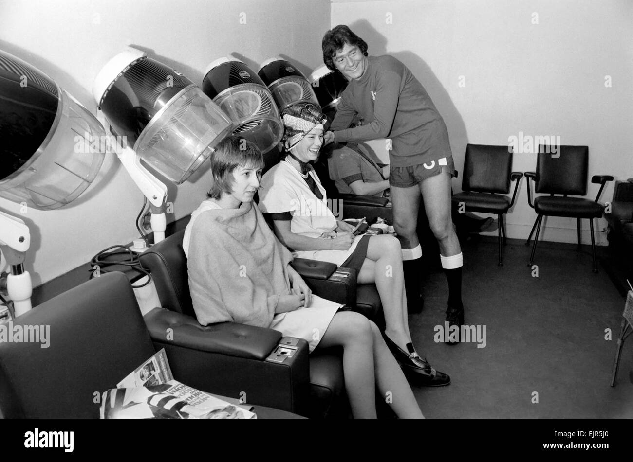 Football fan Vidal Sassoon made a solemn promise that if Chelsea reached the final of the Football League Cup the players and their wives would all get a free hair-do for the occasion. Chelsea are in the Final and Vidal kept this promise. Vidal Sassoon dressed in Chelsea's Football strip seen in the women's hairdressing salon attending to some clients . March 1972 72-2010-004 Stock Photo