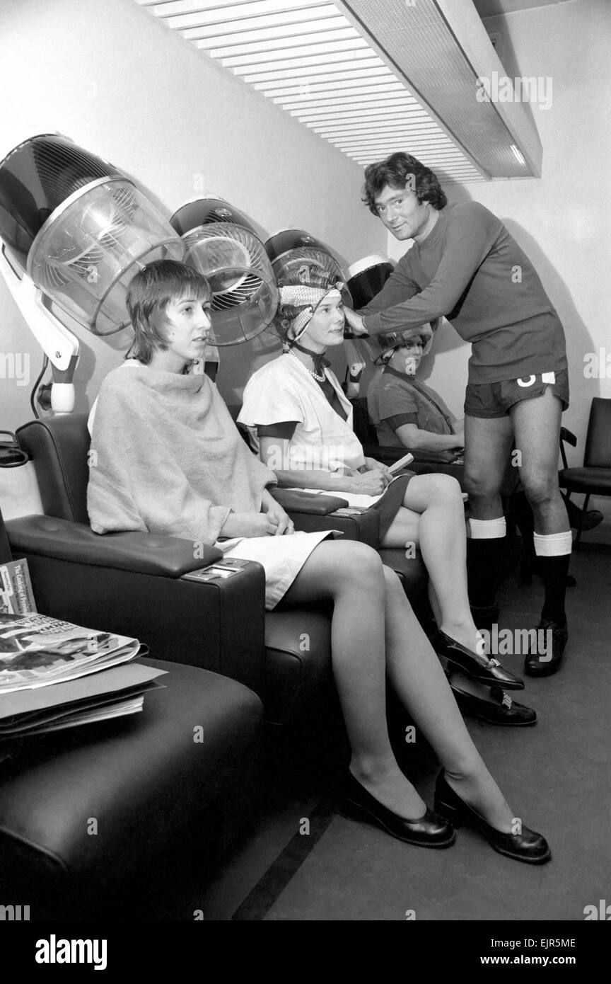 Football fan Vidal Sassoon made a solemn promise that if Chelsea reached the final of the Football League Cup the players and their wives would all get a free hair-do for the occasion. Chelsea are in the Final and Vidal kept this promise. Vidal Sassoon dressed in Chelsea's Football strip seen in the women's hairdressing salon attending to some clients . March 1972 72-2010-003 Stock Photo
