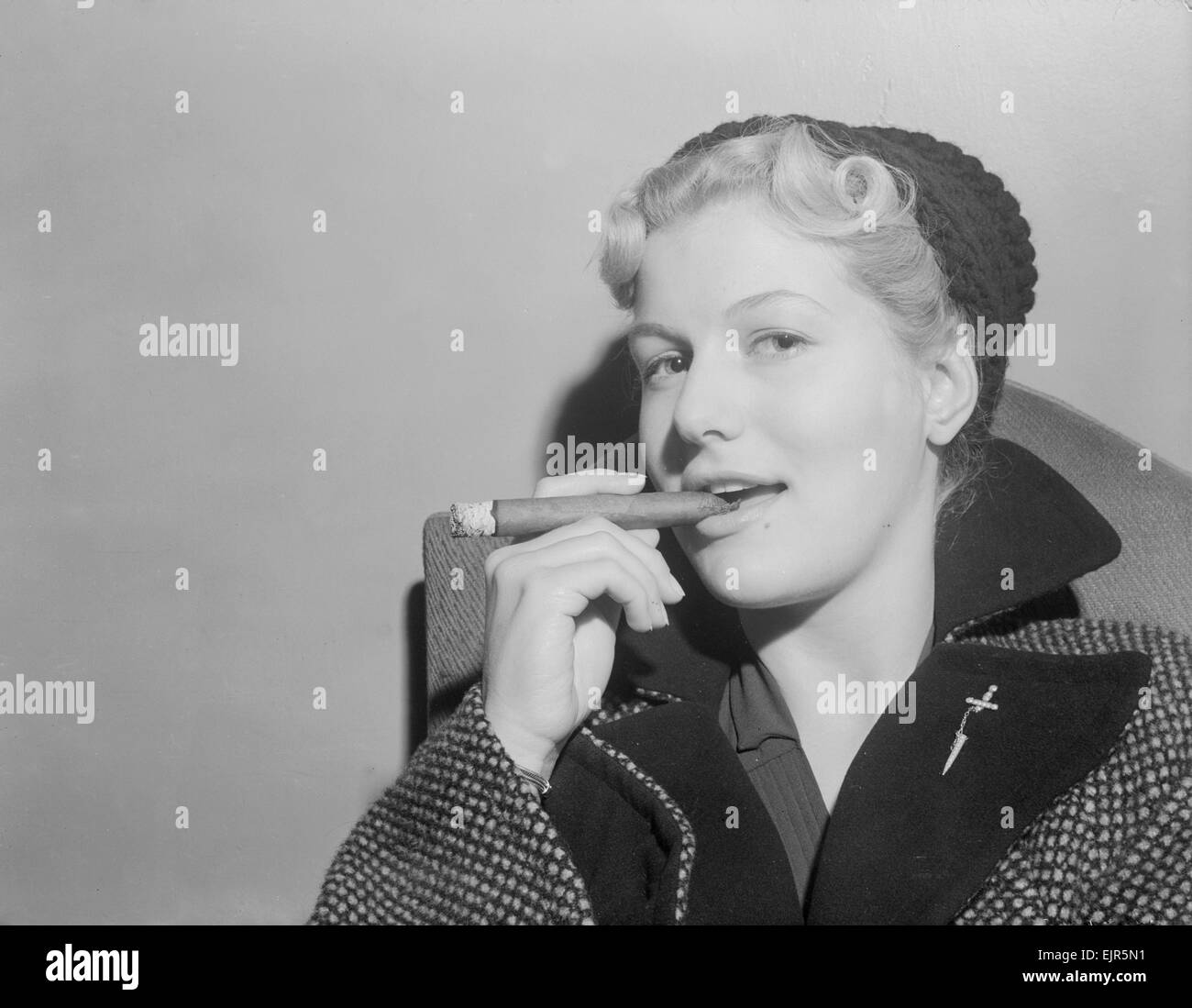 British actress Mary Germaine seen here smoking a cigar. 18th September 1952 Stock Photo