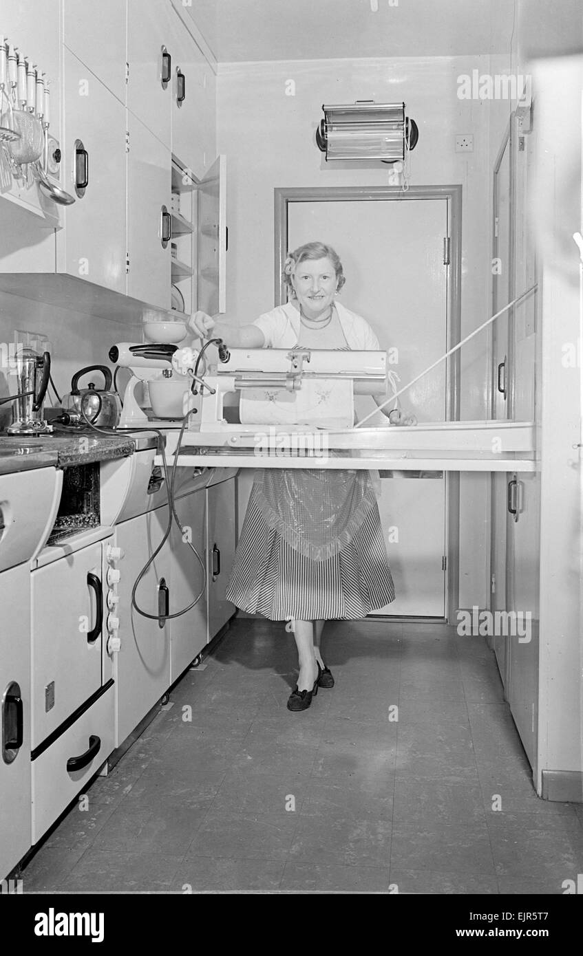 Mrs Susan Davies seen here using her rotary iron in a kitchen full of labour saving gadets. 14th September 1952 Stock Photo