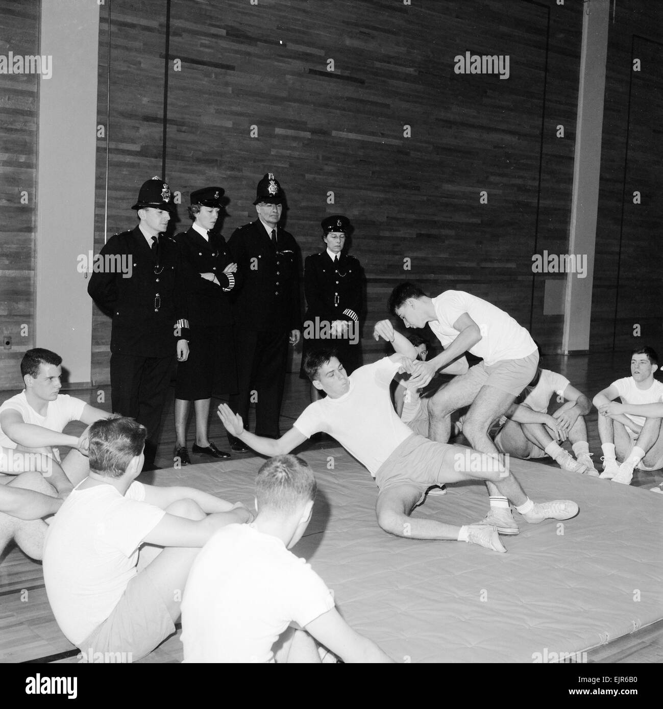 English police officers watch & take part in a hand to hand fighting training session at a Police Academy in New York 2nd October 1964. *** Local Caption *** WatScan - - 05/01/2010 Stock Photo