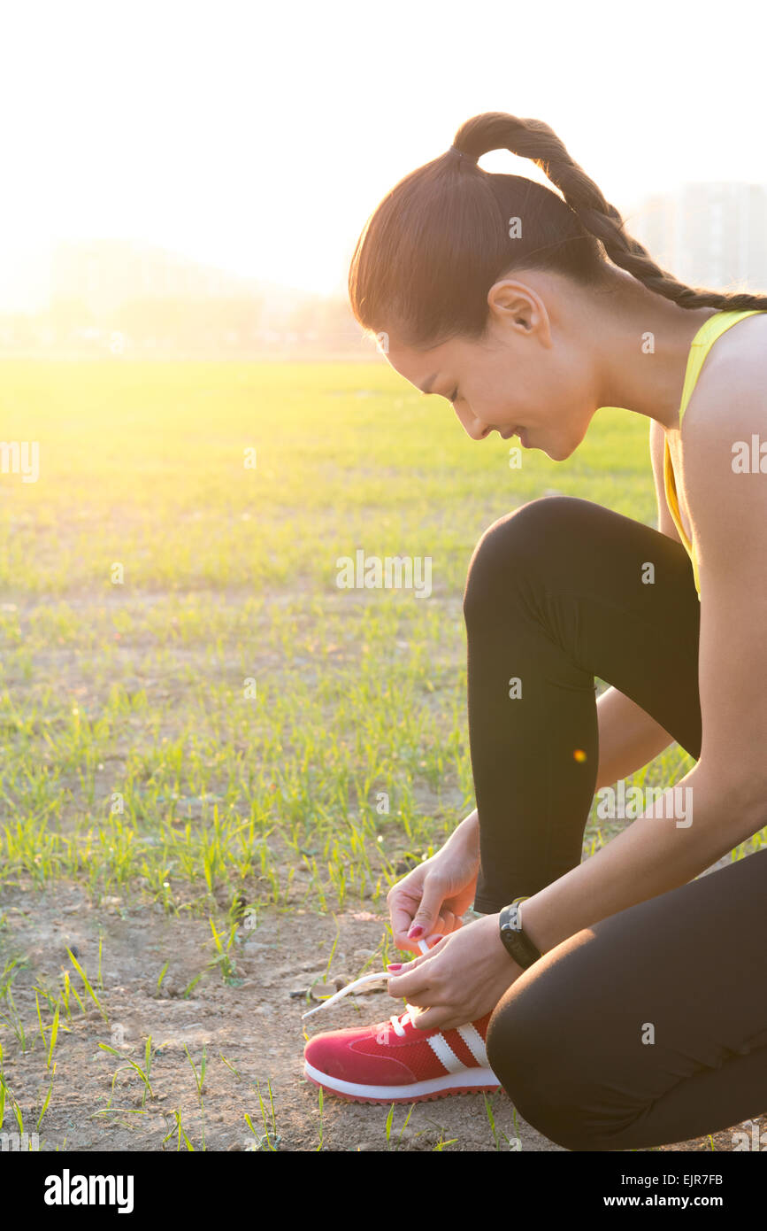 Young woman bending over outdoors hi-res stock photography and images ...