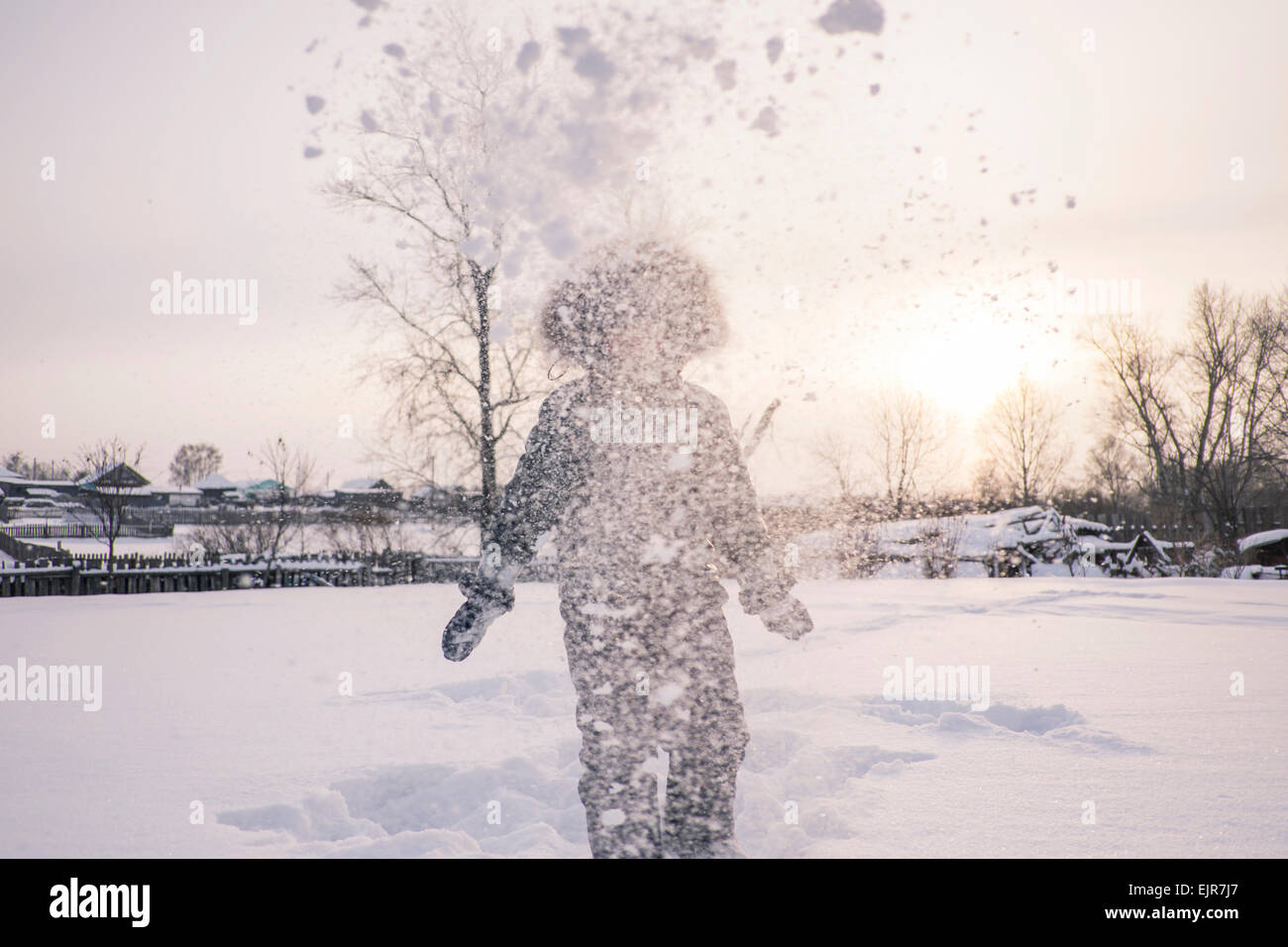Mari boy in parka playing in snowy field Stock Photo
