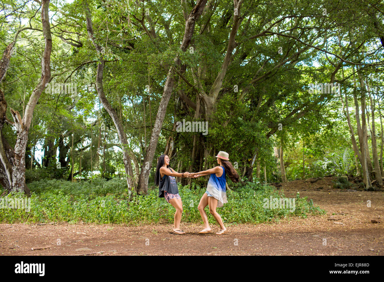 Pacific Islander women playing in forest Stock Photo
