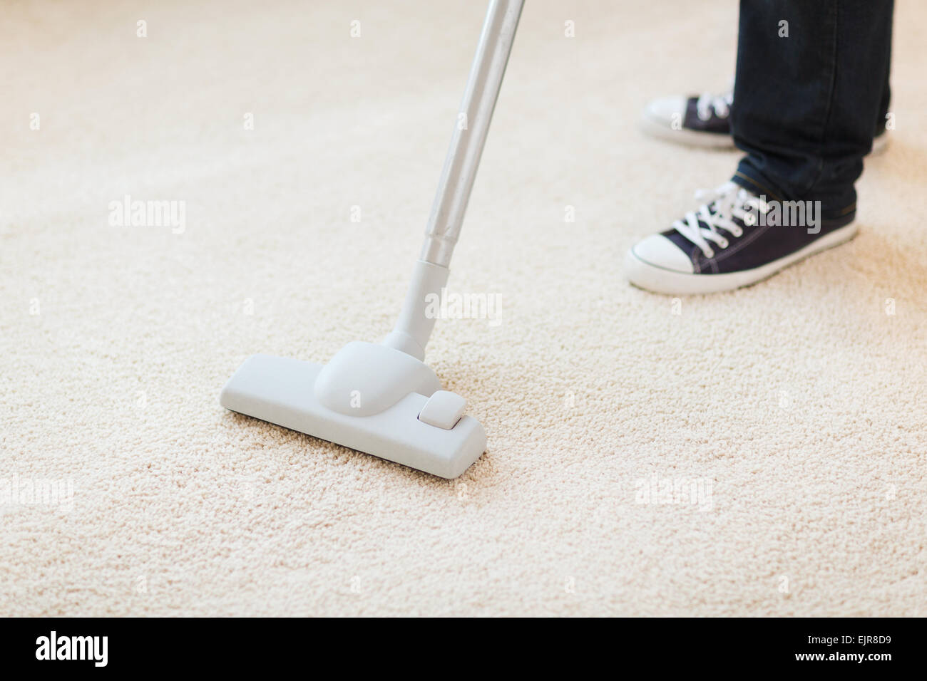 close up of male hoovering carpet Stock Photo Alamy