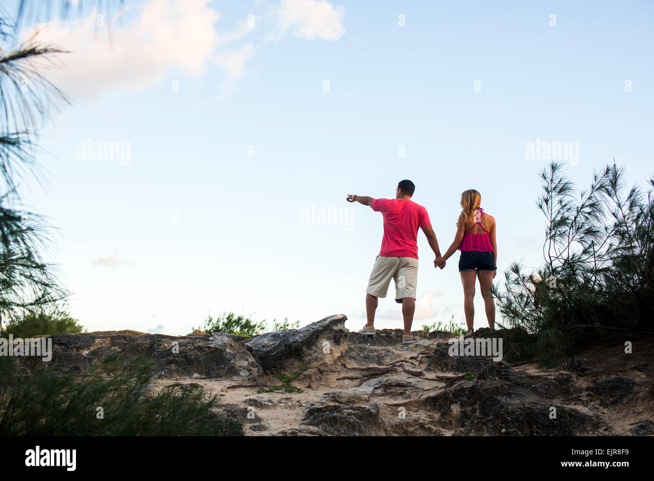 Low angle view of couple enjoying scenic view at beach Stock Photo
