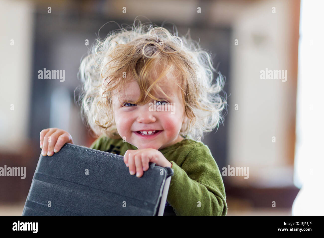 Caucasian baby boy holding digital tablet Stock Photo