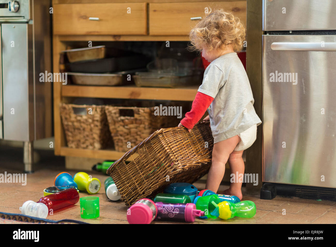 Caucasian baby boy playing with toys and basket Stock Photo