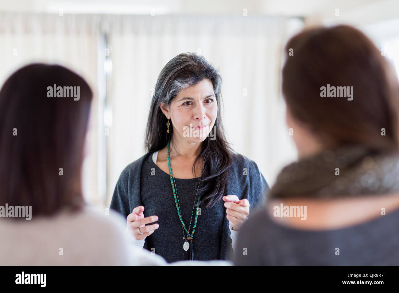Small business owner talking to customers in store Stock Photo