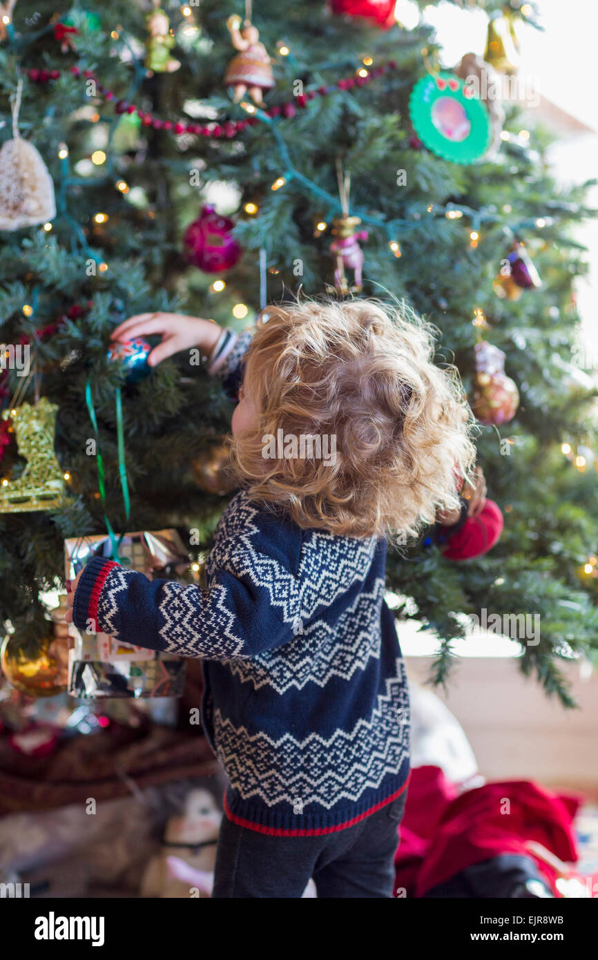 Caucasian baby boy decorating Christmas tree Stock Photo
