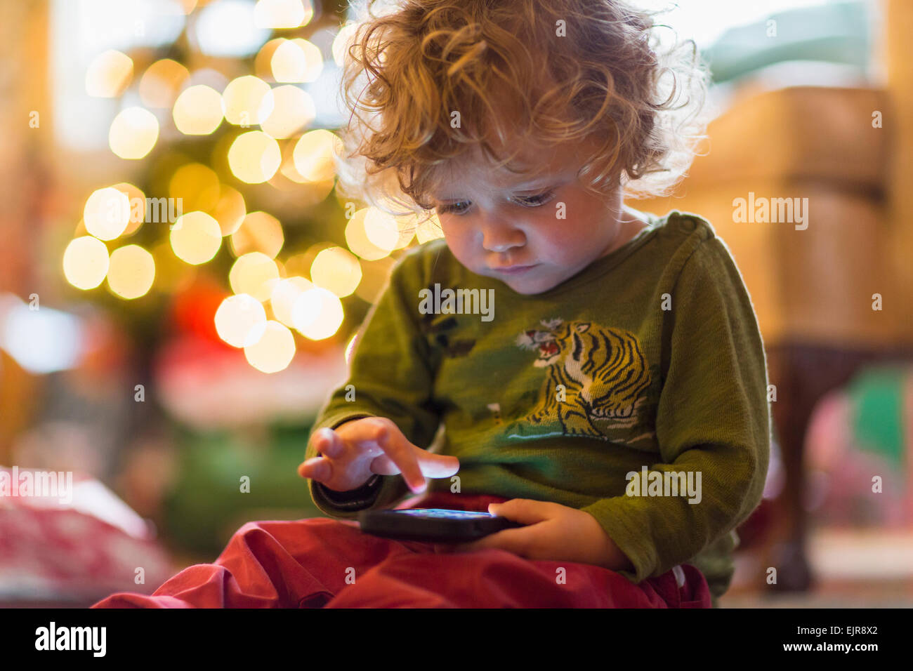 Caucasian baby boy playing with cell phone Stock Photo